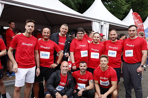  Group photo of CoroplastGroup employees in front of the company tent
