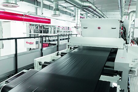 Adhesive tape master spool running through a production machine