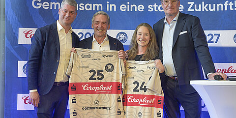 BHC’s managing directors raise the new team jersey to kick off the celebration.