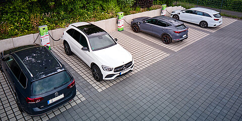 New charging stations at employee parking lots with Coroplast Group branding 