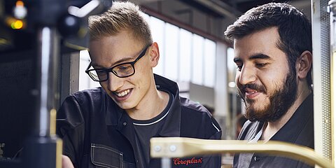 Two young employees at the cable production