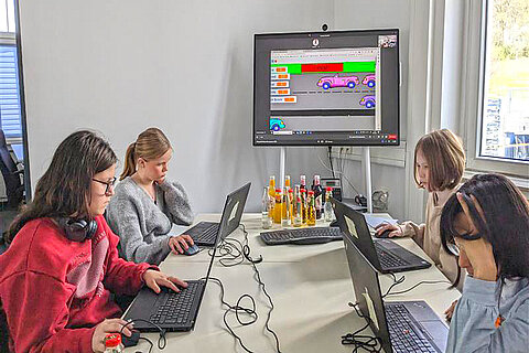 Four girls developing functions for the "Scratch" program