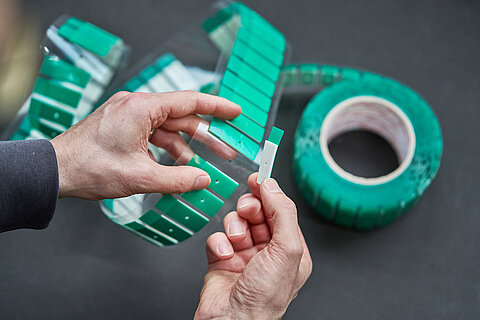 Roll of green die-cut parts