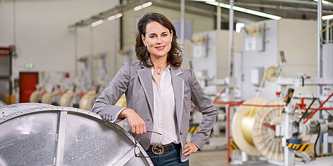 Photo of Natalie Mekelburger in a shop floor of the Coroplast Group