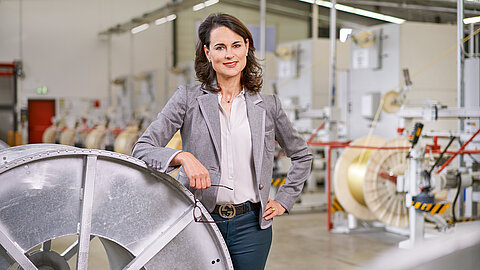 Photo of Natalie Mekelburger in a shop floor of the Coroplast Group